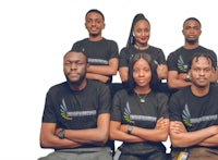 a group of people in black t - shirts posing for a photo